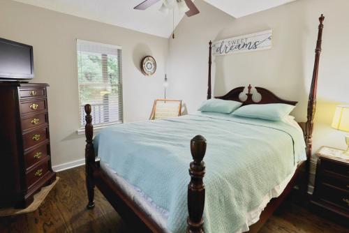 a bedroom with a bed and a dresser and a television at Laurel Creek in Helen