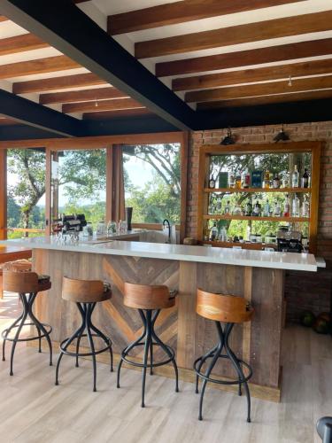 a kitchen with a bar with stools in a room at Cerro Lobo in Entrada