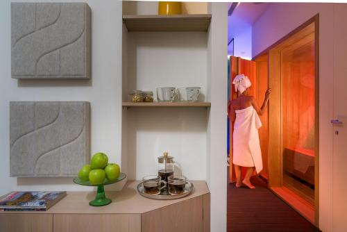 a kitchen with a woman in a dress on a shelf at Duomo Suites & Spa in Catania
