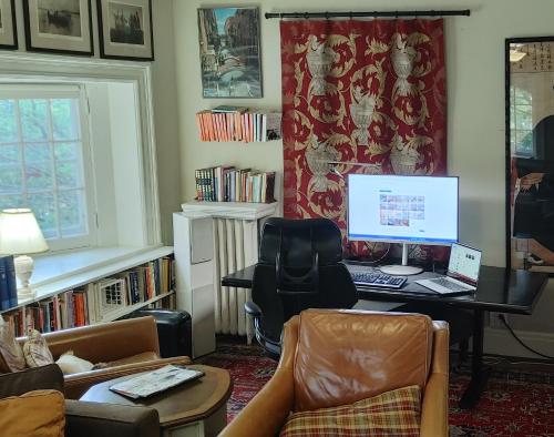 a living room with a desk with a computer on it at Four Bedroom Rosedale Home in Toronto