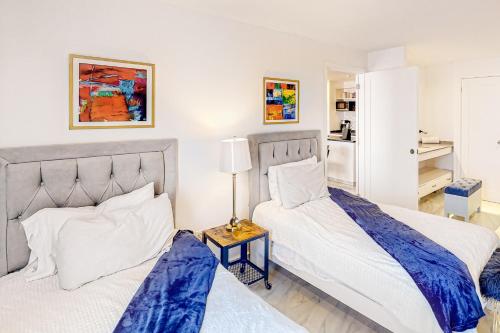 two beds sitting next to each other in a bedroom at Taylor 203 @ Morgan Residences in Cabo San Lucas