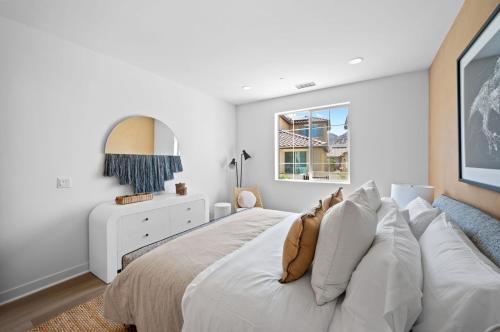 a white bedroom with a large white bed with pillows at BRAND NEW La Quinta Home in Signature at PGA West in La Quinta