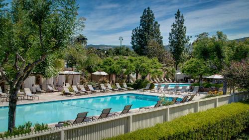 a pool with a pool table and chairs in it at Silverado Resort and Spa in Napa