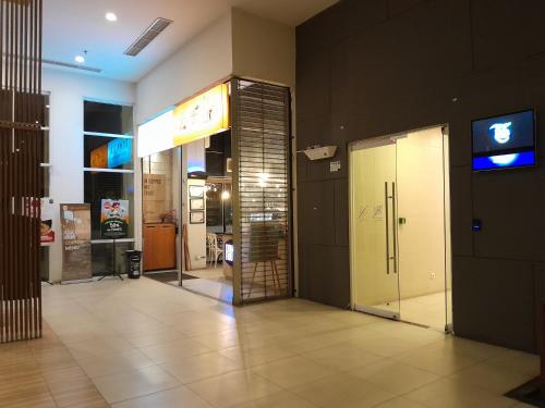 a lobby with an elevator in a building at Tamansari Mahogany Apartment By Sagita Residence Karawang in Karawang