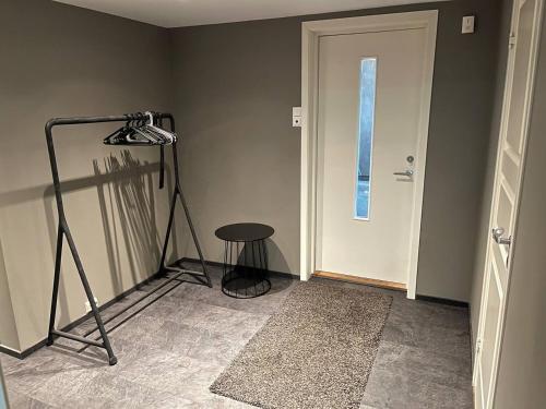 a room with a camera on a tripod next to a door at A Cozy Place To Stay Over in Tysvær