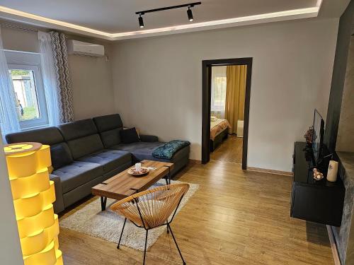 a living room with a couch and a table at AeroVista Apartment in Surčin