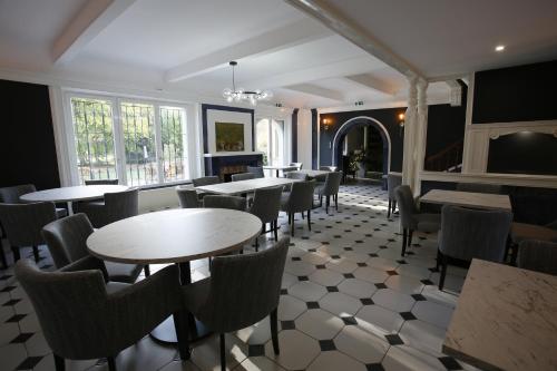 a restaurant with tables and chairs in a room at Le Moulin de Saint-Aulaye in Saint-Aulaye