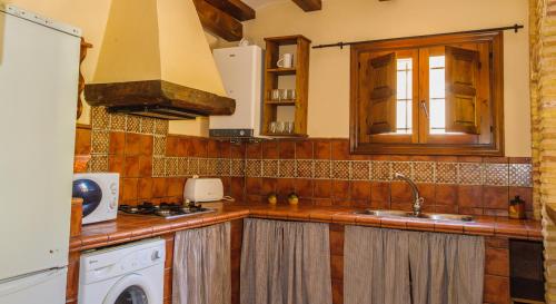 a kitchen with a sink and a stove at Casas rurales Batan Rio Tus in Yeste