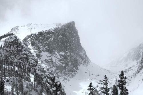 a snow covered mountain with trees in front of it at Holiday Inn Estes Park by IHG in Estes Park