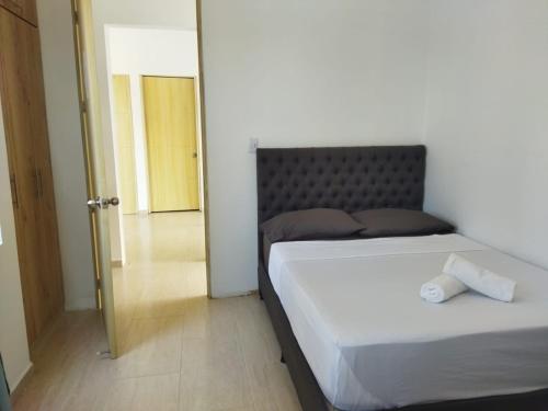 a bedroom with two beds and a door to a hallway at El Encanto casa de descanso in Rivera
