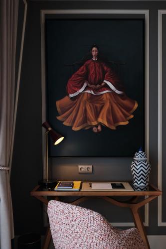 a painting of a man sitting on a tv screen at GA Palace Hotel & Spa, a XIXth-Century Villa in Porto