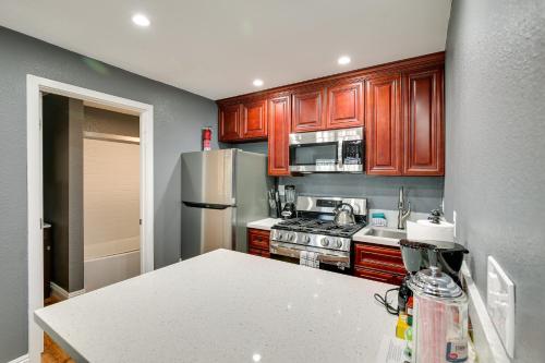 a kitchen with wooden cabinets and a white counter top at Hidden Gem in Hawthorne about 3 Mi to SoFi Stadium in Hawthorne