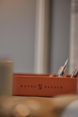 a wooden holder with pens in it on a table at GA Palace Hotel & Spa, a XIXth-Century Villa in Porto