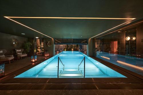 a large swimming pool in a building at GA Palace Hotel & Spa, a XIXth-Century Villa in Porto