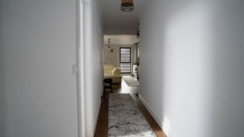 a hallway leading to a living room with a couch at DownTown Apartments in Rădăuţi