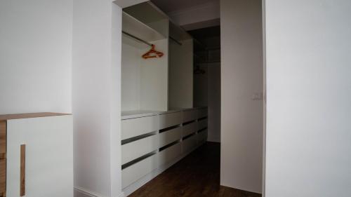 a room with white walls and a white closet at DownTown Apartments in Rădăuţi