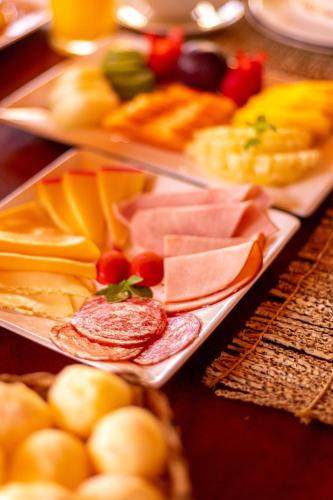 a tray of different types of food on a table at Pousada Vila Sagui in Maragogi