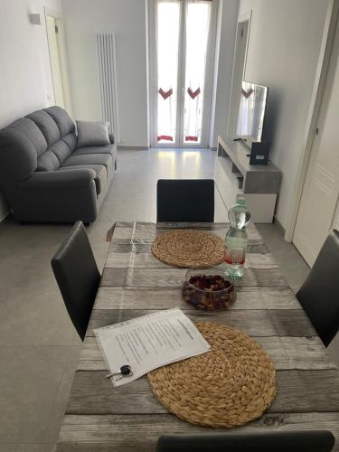 a living room with a table and a couch at Deluxe Apartment Self Check in Parking in Genova