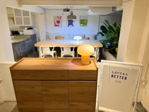 a kitchen with a table and a kitchen better home sign at Letter Better Home in Bangkok