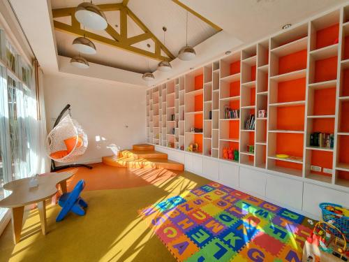 a childs room with a table and a rug at Beachfront Phuket in Bang Tao Beach