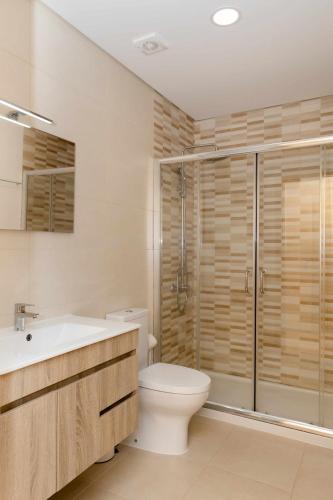 a bathroom with a toilet and a shower and a sink at Casa dos Mirtilos Draper T6 in Celorico de Basto