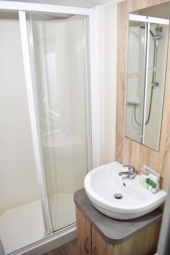 a bathroom with a sink and a shower at Rio Gold LC20 in Minehead