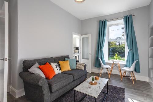 a living room with a couch and a window at Beautiful Ground Floor Apartment in Perth