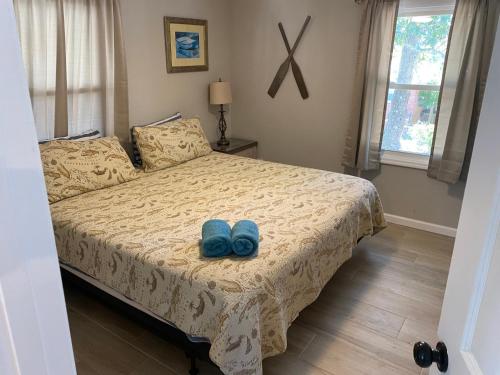 a bedroom with a bed with two blue shoes on it at ON Deck few Blocks Fr BEACH 6 BR/4Ba Newly Reno in Myrtle Beach