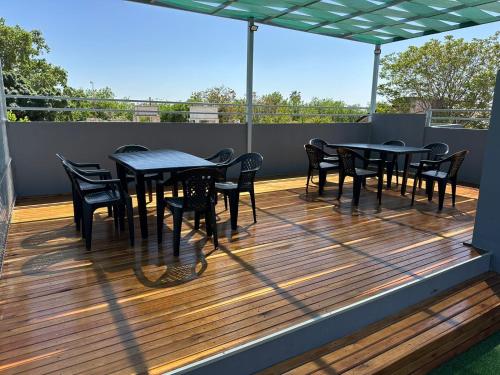 a patio with tables and chairs on a deck at Departamento en capital Mendoza 2 ubicadisimo estacionamiento incluido in Mendoza