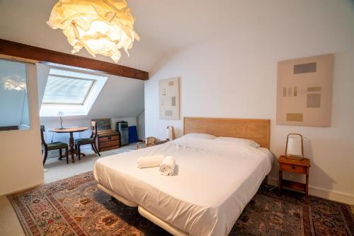 a bedroom with a large bed and a dining room at Cabana & Au Coeur du Village in Talloires