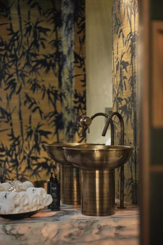 a bathroom with a brass sink in a room at GA Palace Hotel & Spa, a XIXth-Century Villa in Porto