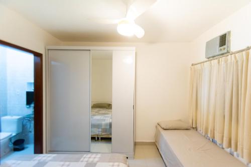 a bedroom with a bed and a sliding glass door at HOSTEL DIKASA in Cuiabá