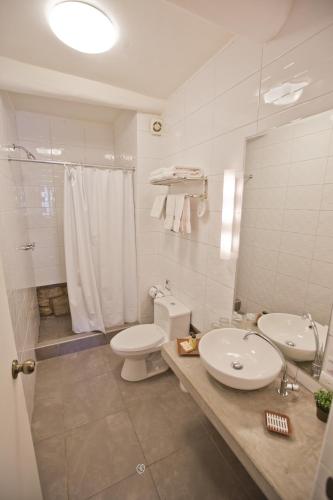 a bathroom with a sink and a toilet and a shower at Tierra Viva Cusco Centro in Cusco