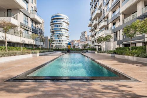 a swimming pool in a city with tall buildings at Seba Suites with Fitness And Pool in Istanbul
