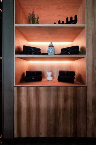 a wooden shelf with a vase on it at GA Palace Hotel & Spa, a XIXth-Century Villa in Porto