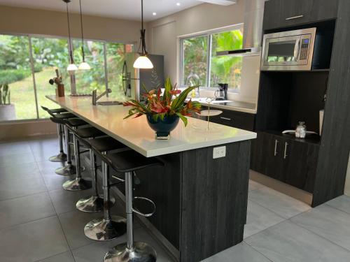 a kitchen with a large island with a counter top at Modern House for Families A/C in Turrialba