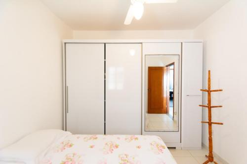 a bedroom with a bed and a mirror at HOSTEL DIKASA in Cuiabá