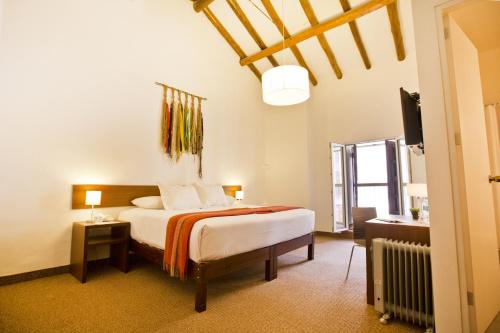 a bedroom with a bed and a television in it at Tierra Viva Cusco Centro in Cusco