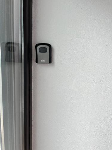 a door with a lock on the side of a wall at Harbour View Cottage, Rochespoint, Cork Harbour in Midleton