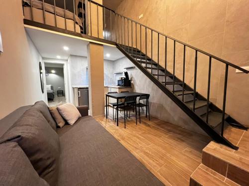 a living room with a couch and a staircase at VLC Apart in Valencia