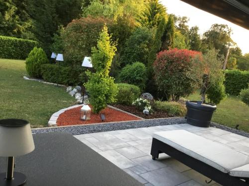 a patio with a bench and a garden at Suite Couture in Ernestviller