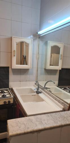 a kitchen with a sink and a counter top at Maadi International Center Apartments in Cairo