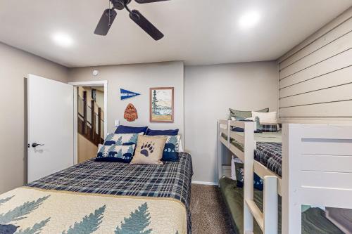a bedroom with two bunk beds and a ceiling fan at Huntington Lake Condo #102 in Lakeshore