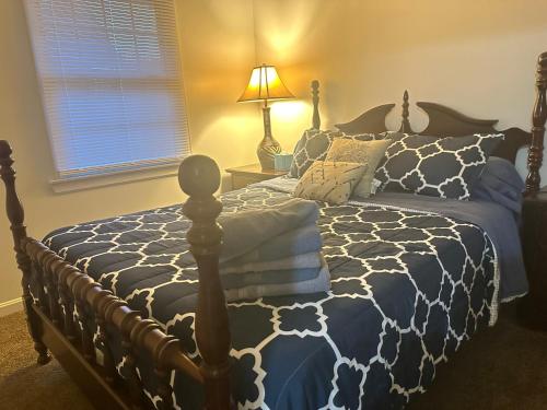 a bedroom with a bed with a blue and white comforter at The Trenton Gallery in Trenton