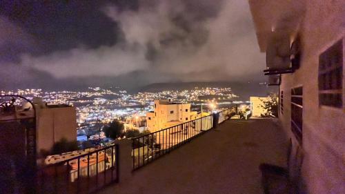 a view of a city at night from a balcony at Sara apartment in Wadi Musa