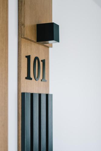 a wooden clock with the number on it at Hotel Restaurant Kod Barića in Grude