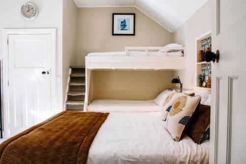 a bedroom with two bunk beds and a staircase at Lisnacurran in Hillsborough