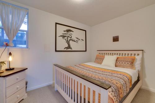 a bedroom with a bed and a dresser and a window at Chic Port Angeles Home with Oceanfront Balcony! in Port Angeles