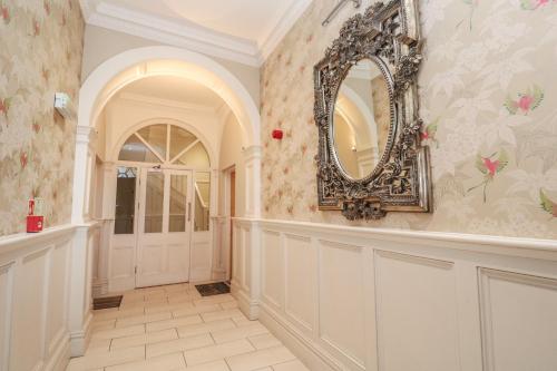 a hallway with a mirror on the wall at The Penthouse in Helston