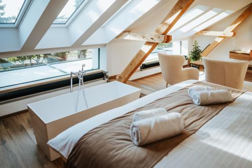 a bedroom with a large bed and a large window at Galerie mlýn Žeraviny in Žeraviny